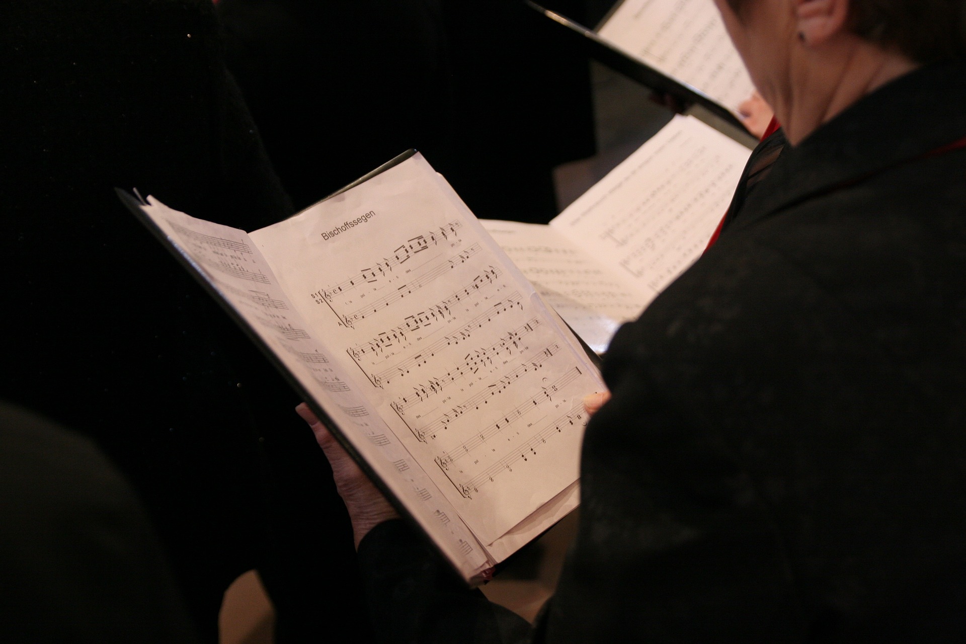 Person holding music sheet